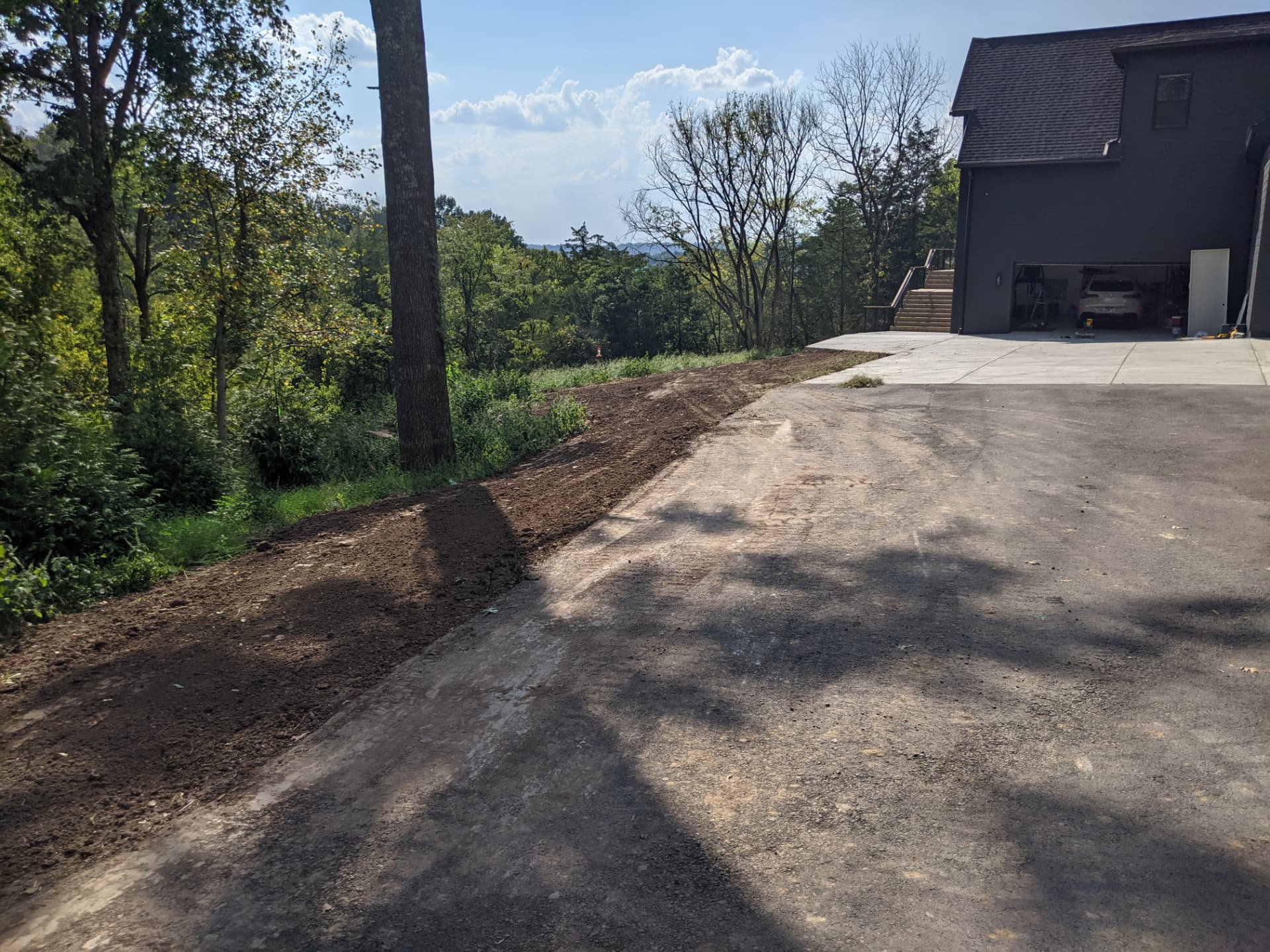 Freshly finish-graded driveway edge beside a Columbia TN home