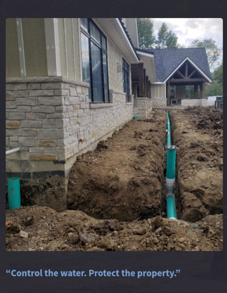 Green rigid smooth-wall drainage pipe installed beside a house