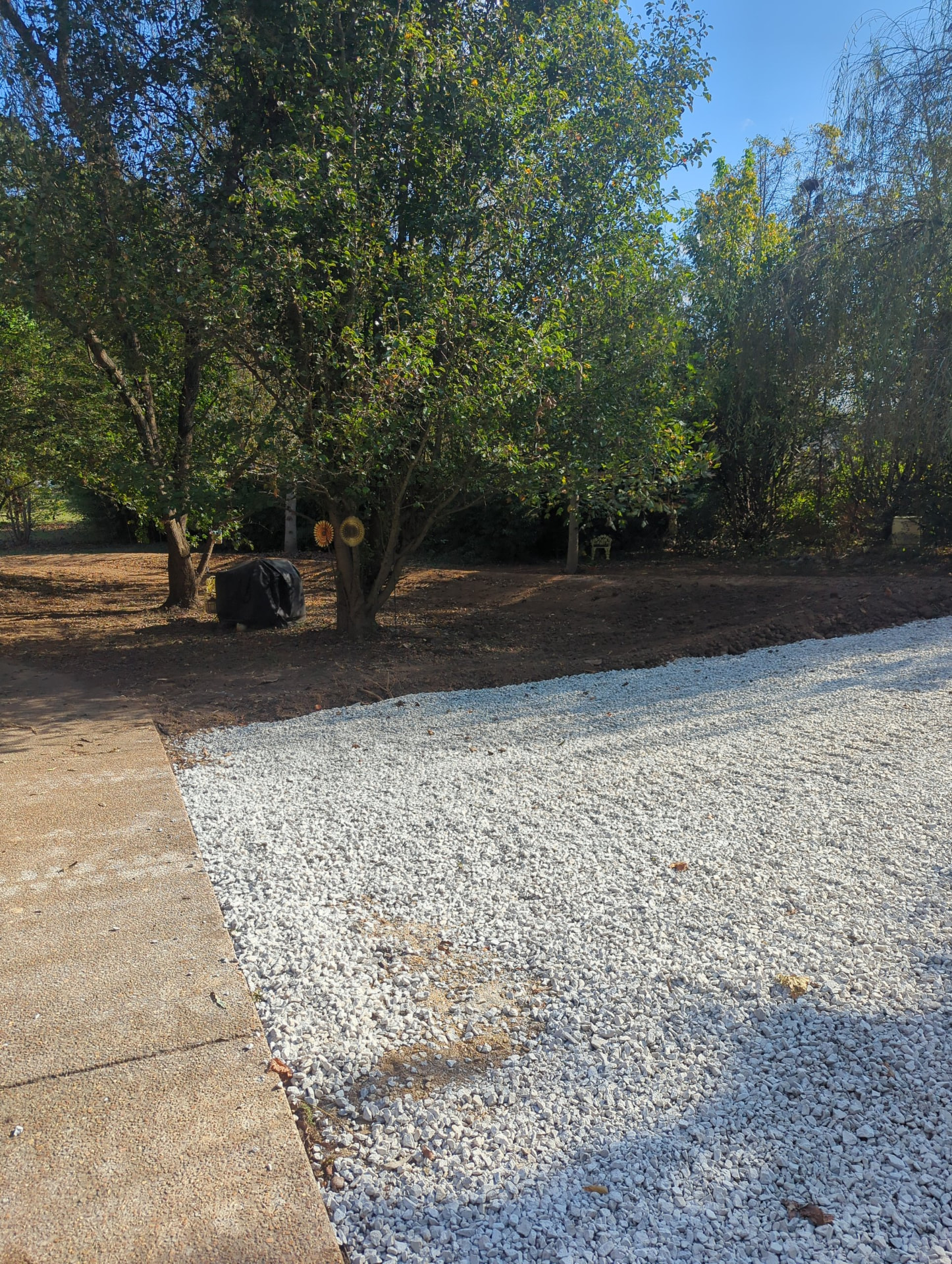 #57 stone driveway base meeting the existing concrete apron in Spring Hill TN