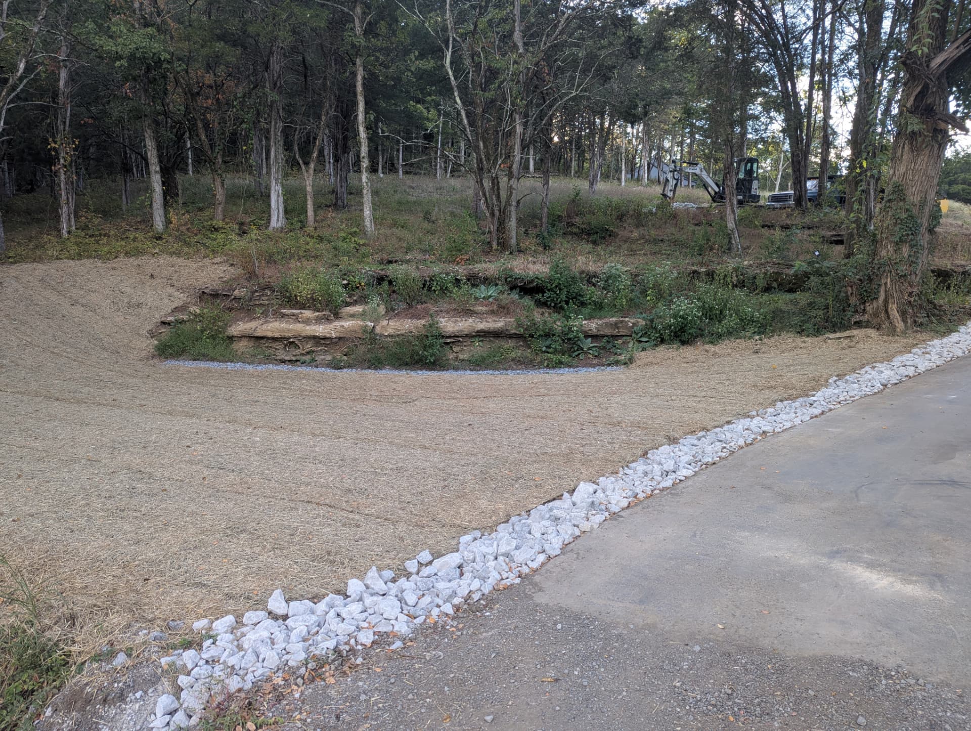 Hillside grading and erosion-control blanket beside finished drainage in Columbia TN