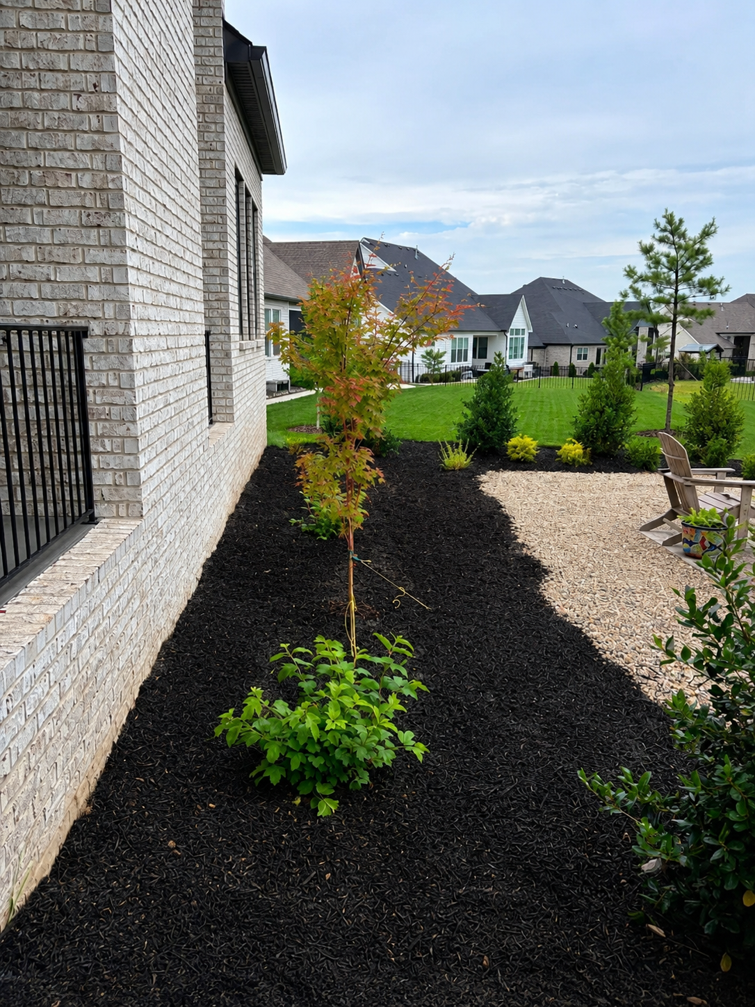 Completed Franklin TN drainage and grading project by CANDO LLC with restored landscape bed, fresh mulch, and proper drainage away from the home