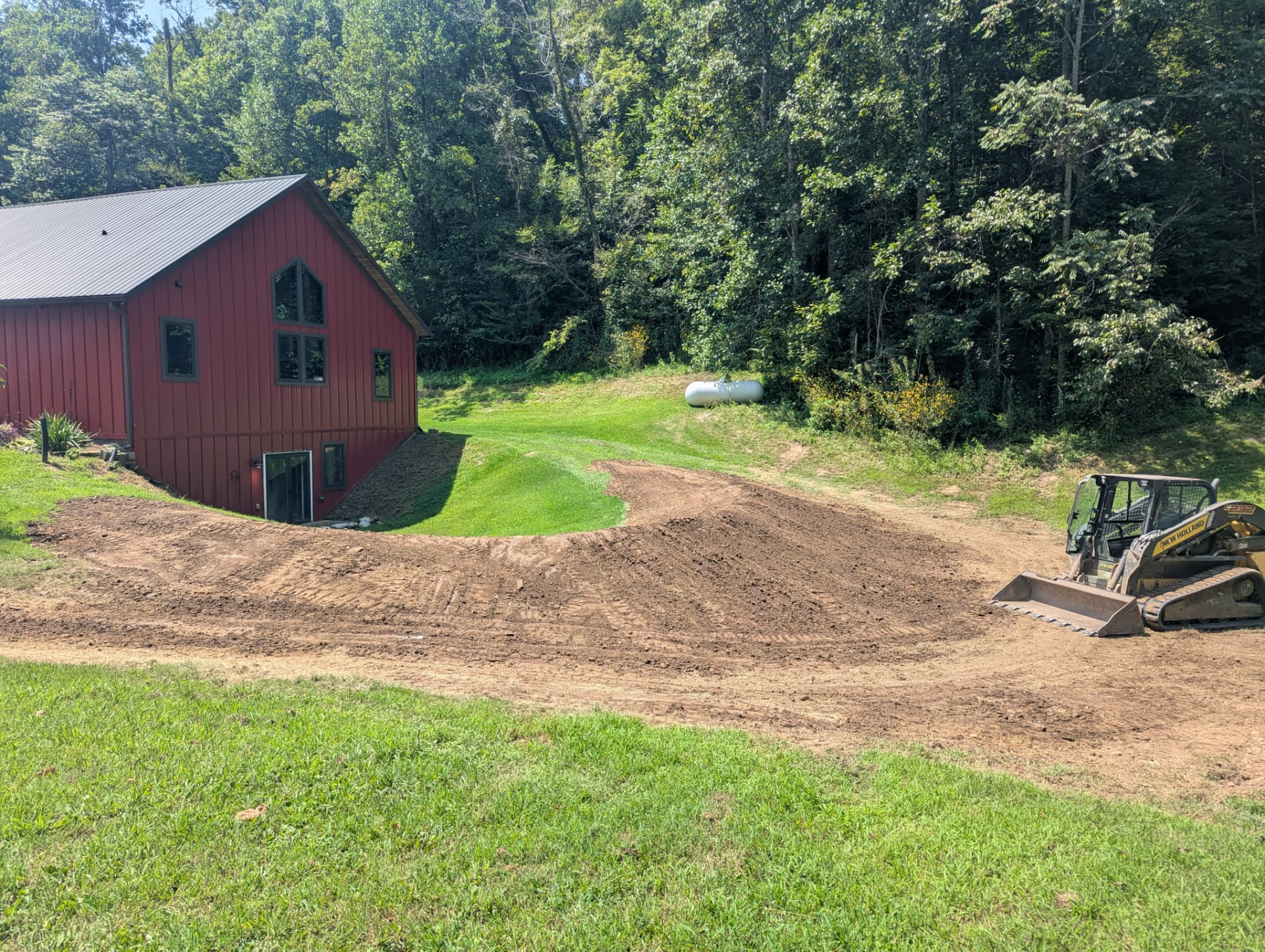 Completed drainage berm shaping near a walkout basement in Columbia, TN.