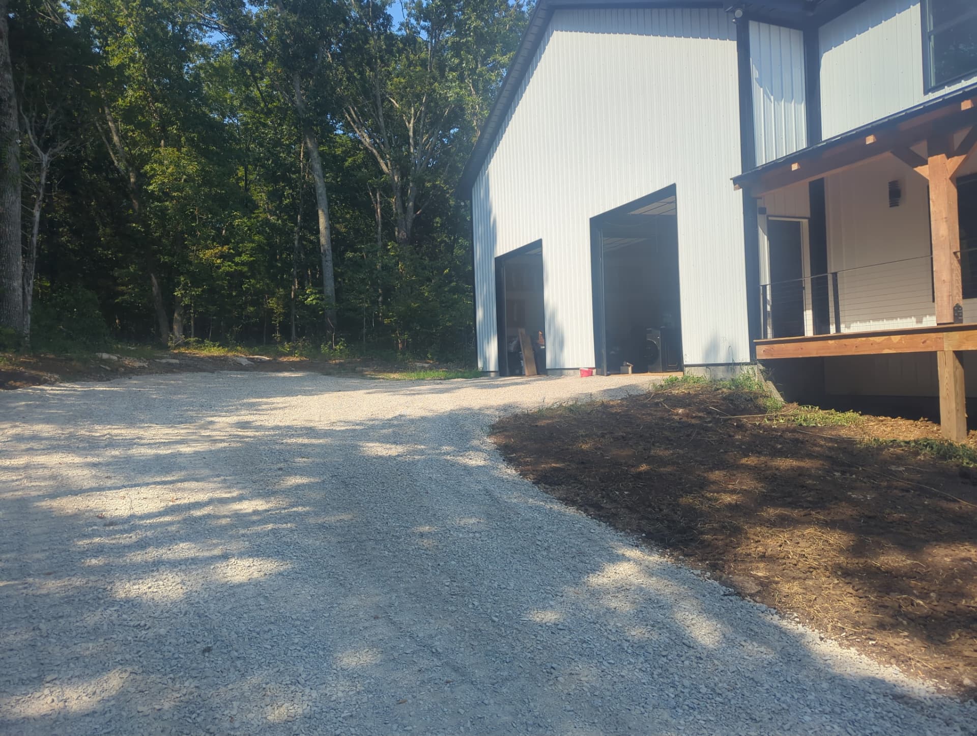 Crusher run driveway and corrected grading beside barndominium garage in Columbia TN