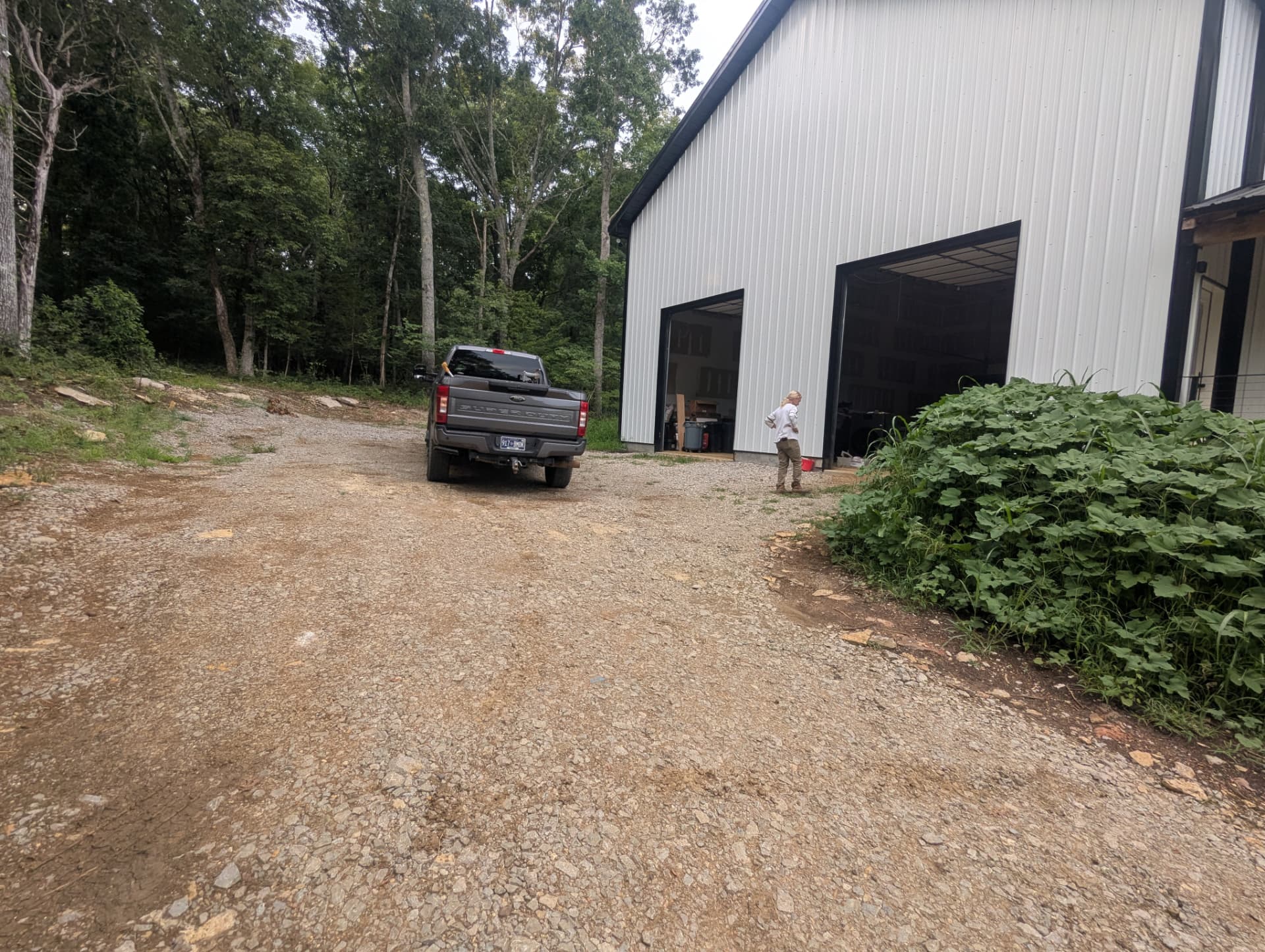 Existing gravel driveway and unfinished grading beside a new barndominium in Columbia Tennessee before excavation work