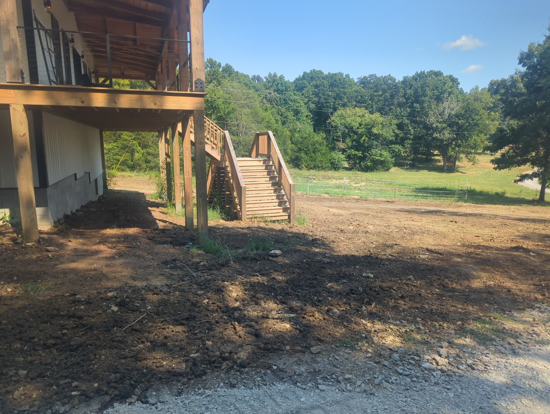 Corrected drainage grade beside barndominium stairs after excavation in Columbia TN