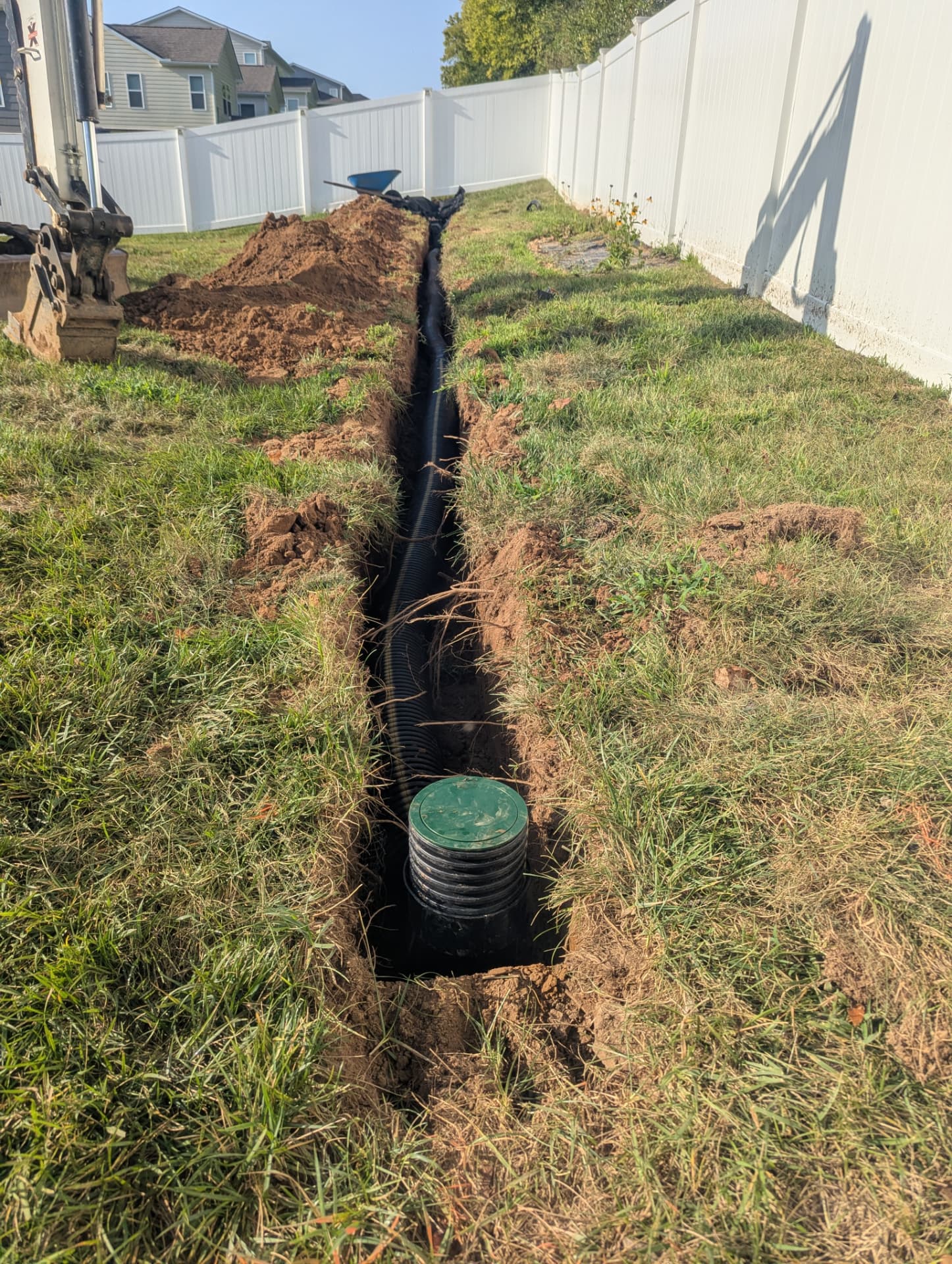 Six inch underground stormwater drainage pipe installation across residential backyard
