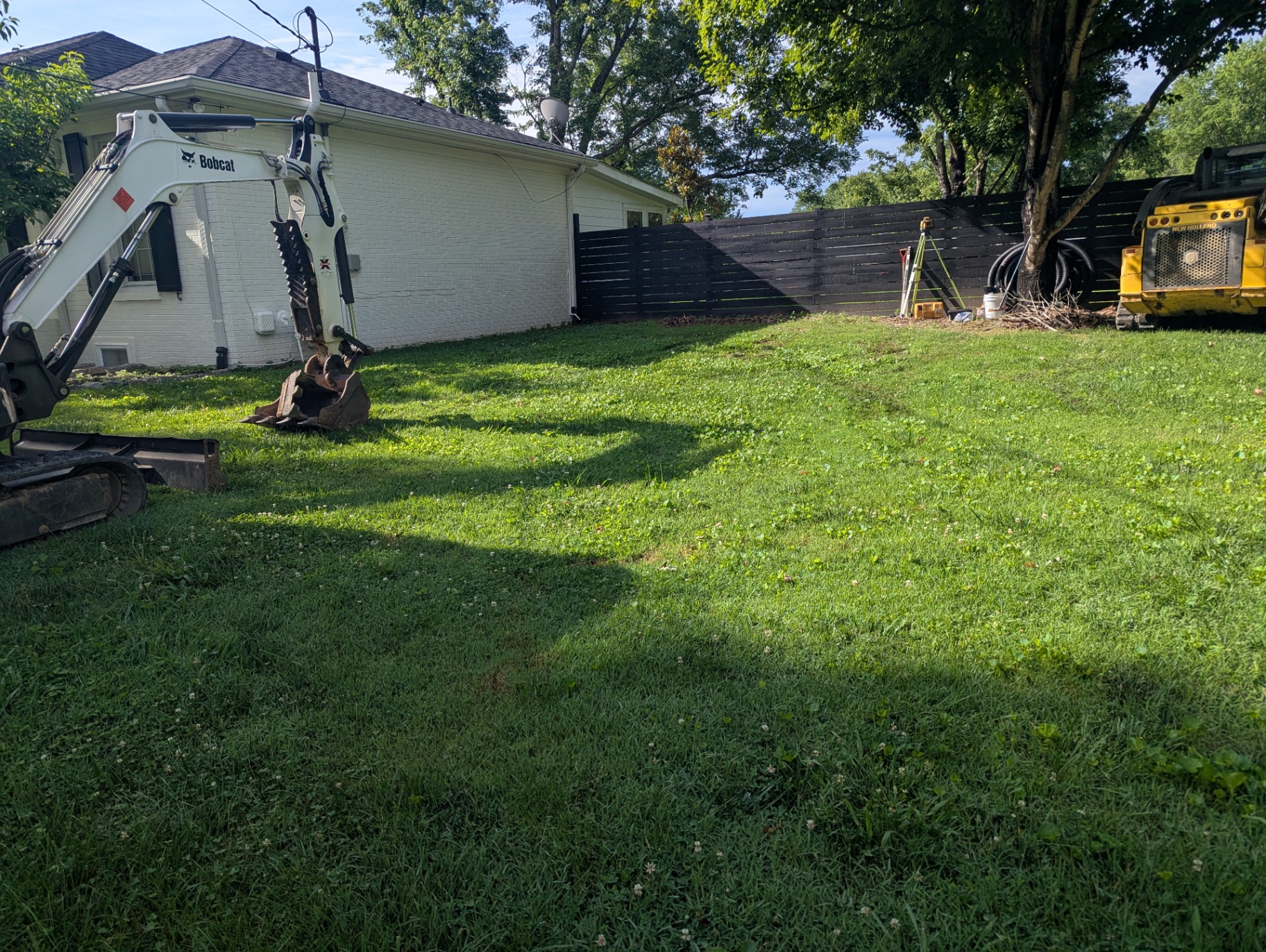 Williamson County TN backyard before grading showing negative slope toward the home foundation